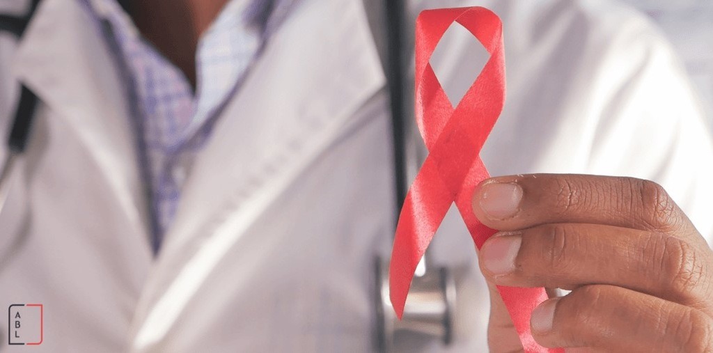 médico segurando fita vermelha representando se quem tem HIV pode se aposentar
